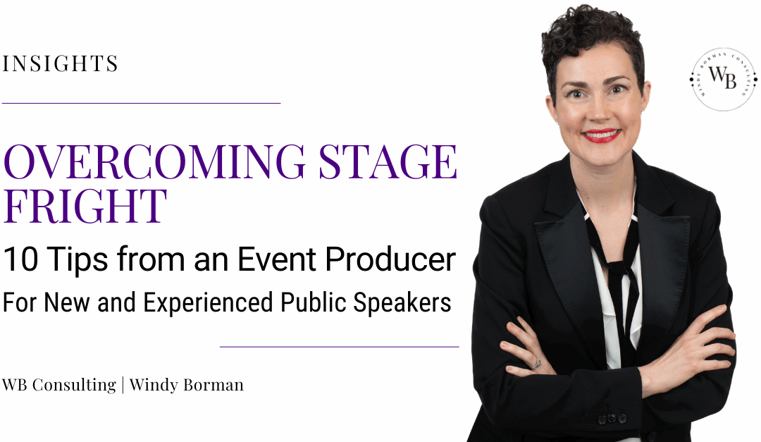 Windy Borman, a woman with short, dark, curly hair, wears a tuxedo jacket, white shirt, and loose black tie. She smiles, wearing red lipstick, and crosses her arms. Windy Borman is a Fractional Director of Content. She helps Founders and CEOs amplify their stories across film, media, and events.